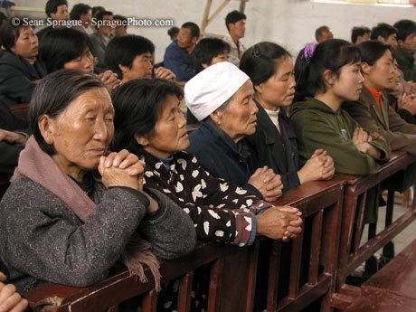 7360 religion china women deep in prayer at mass at the catholic church xinghe village shanxi xian