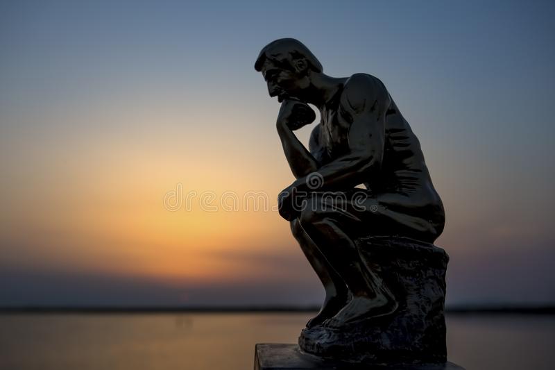 sculpture thinking man sunset silhouette concept photo sculpture thinking man sunset silhouette concept photo 145561872