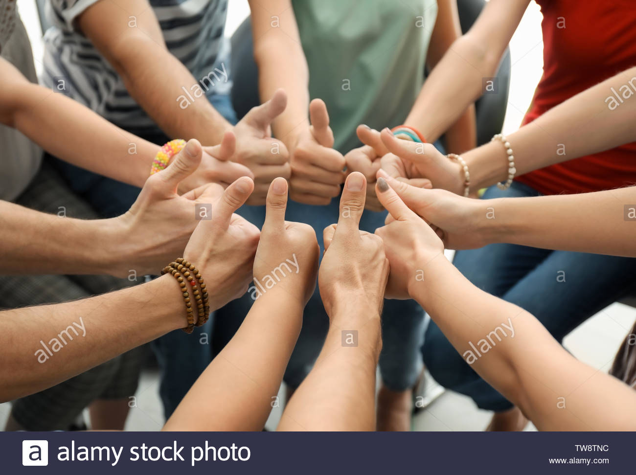 people putting hands together as symbol of unity tw8tnc