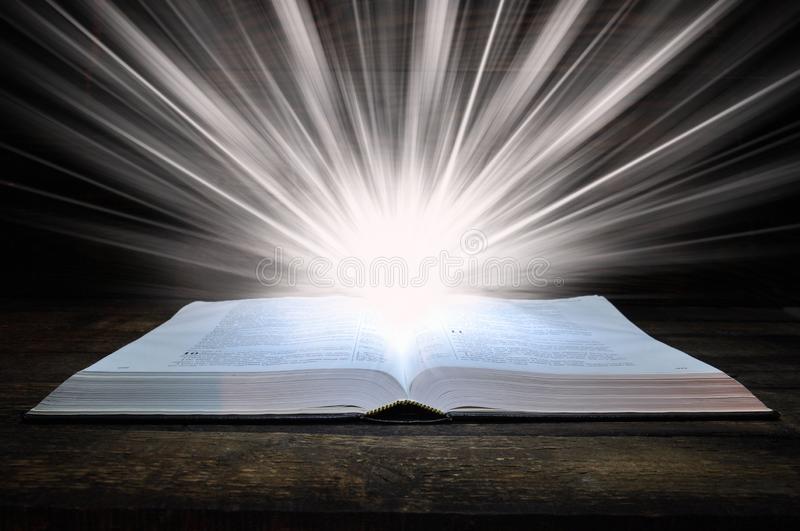 big book bible lies wooden table dark light shines book above light comes out book 149274072